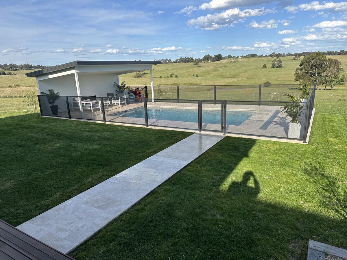 Pure Perf pool fencing in Textured Black beside a sunny backyard pool, Melbourne