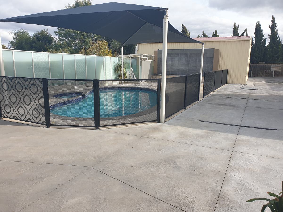 Custom design pool fencing in Textured Black around a round pool, Melbourne