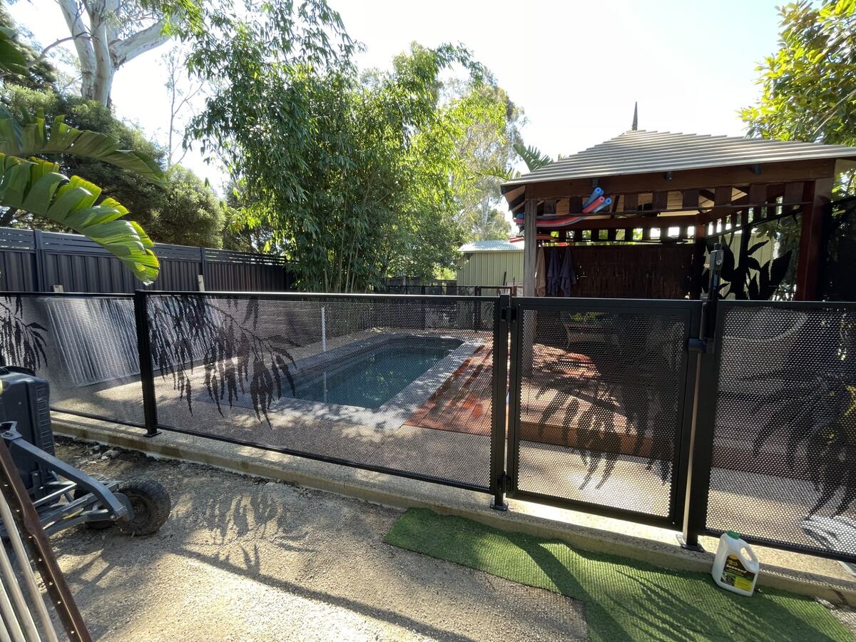 Gum design pool fencing in Textured Black beside a tropical garden, Melbourne