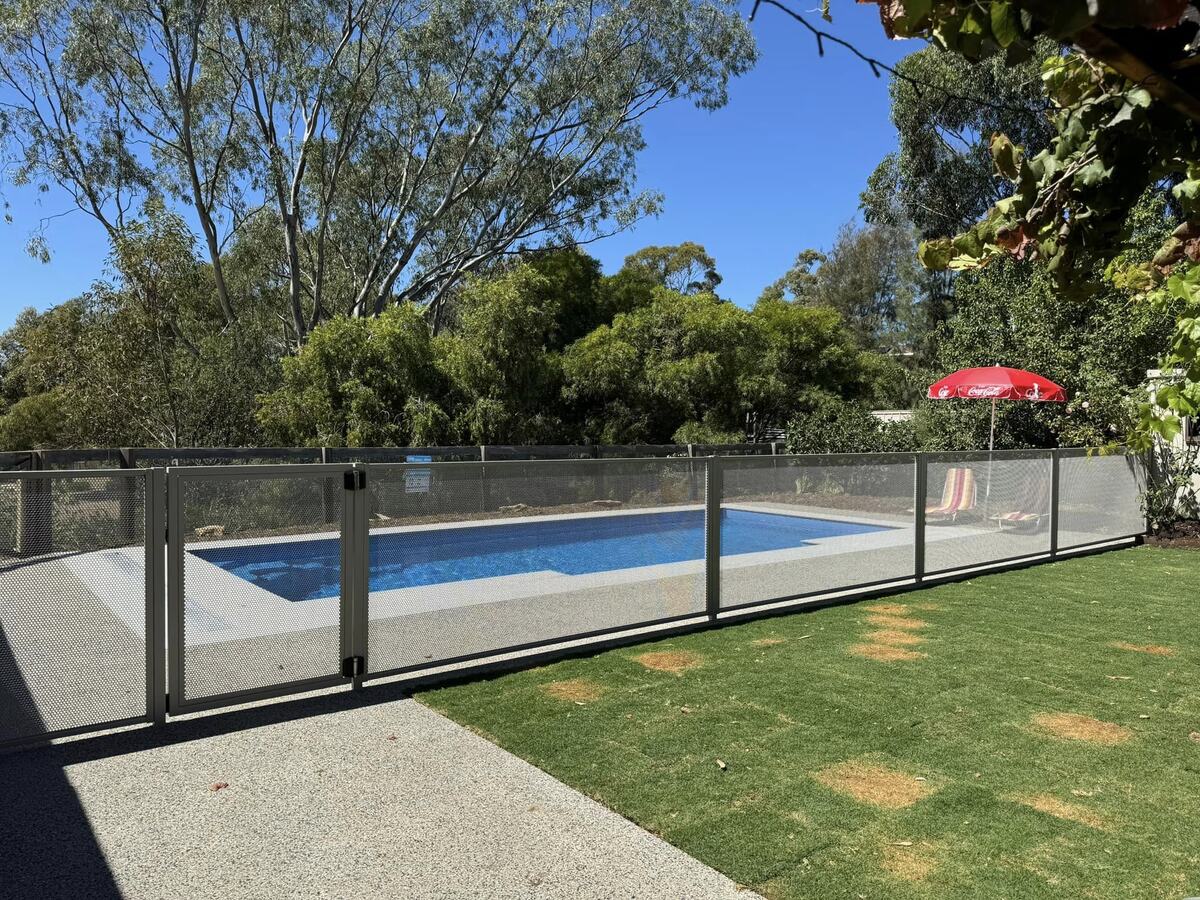 Pure Perf pool fencing in Textured Woodland Grey around a backyard pool, Melbourne
